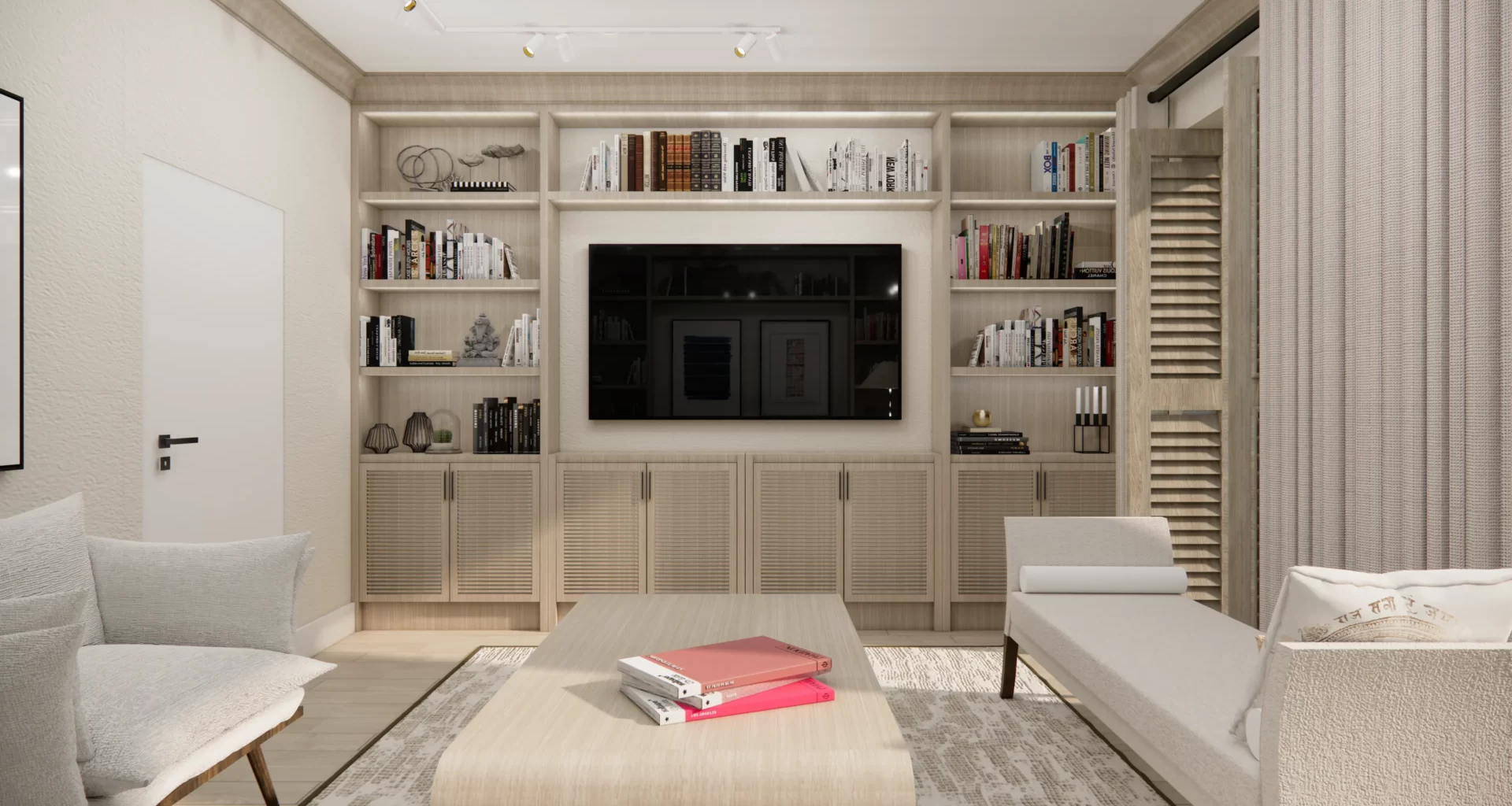 Wnętrze cechuje się jasną, neutralną kolorystyką, która nadaje przestrzeni lekkości i optycznie ją powiększa. W centrum znajduje się zabudowa z półkami, które są ozdobione książkami oraz dekoracjami, dodającymi wnętrzu osobistego charakteru. Telewizor został wkomponowany w środek zabudowy, tworząc funkcjonalną i estetyczną przestrzeń. Całość dopełniają proste, ale stylowe meble – jasne fotele i stolik kawowy, na którym spoczywają książki i magazyny w wyrazistych kolorach.
