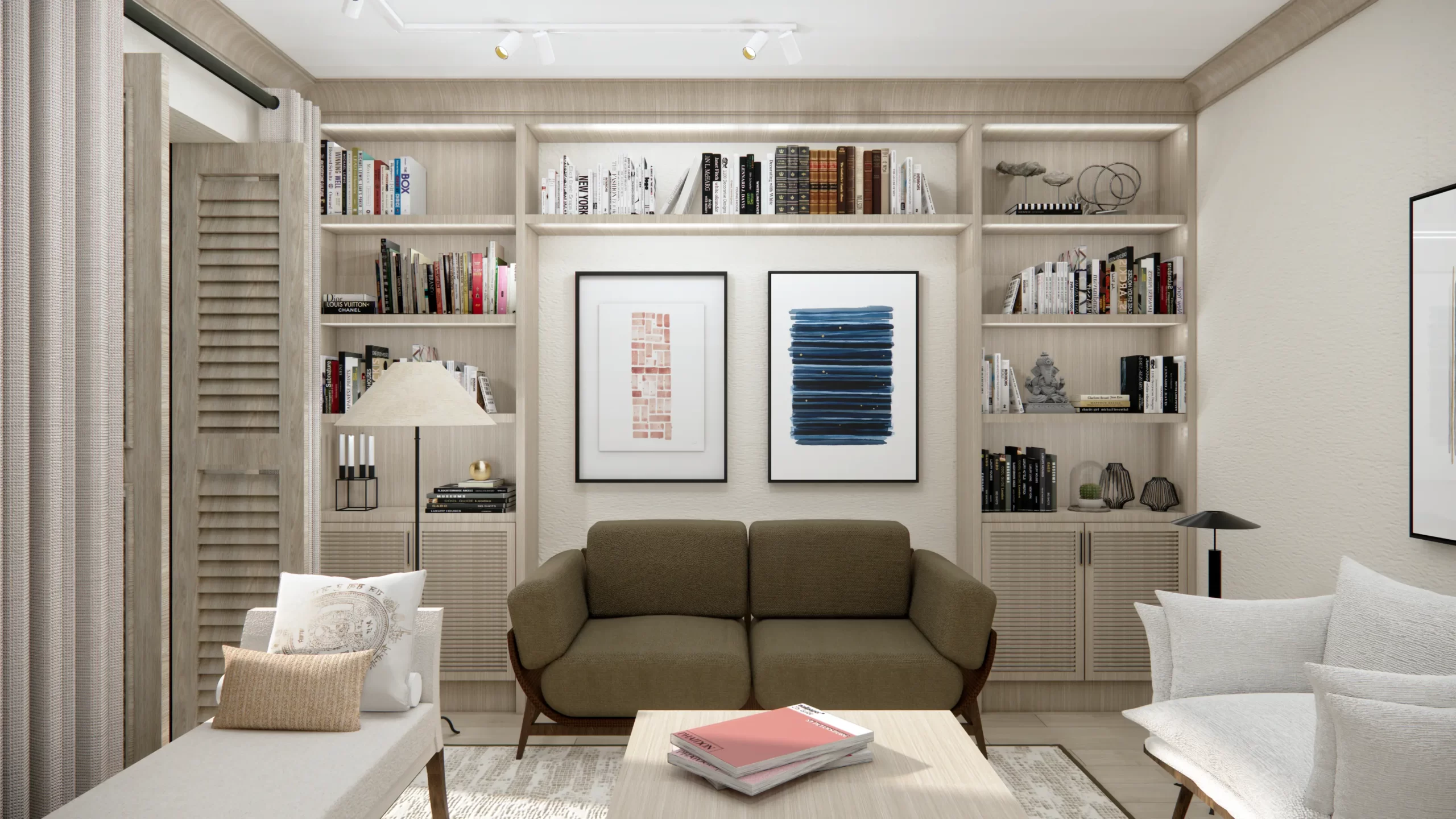 Wyeksponowano oliwkową sofę jako centralny element strefy wypoczynkowej. Zauważalne są także dekoracyjne obrazy w minimalistycznym stylu, które zdobią ścianę za sofą, dodając wnętrzu artystycznego wyrazu. Wnętrze utrzymane jest w jasnej kolorystyce, z dodatkami naturalnego drewna, które ocieplają przestrzeń. Wnękowa zabudowa z półkami stanowi główny element dekoracyjny, a różnorodne książki i dodatki wprowadzają subtelną grę barw i tekstur.