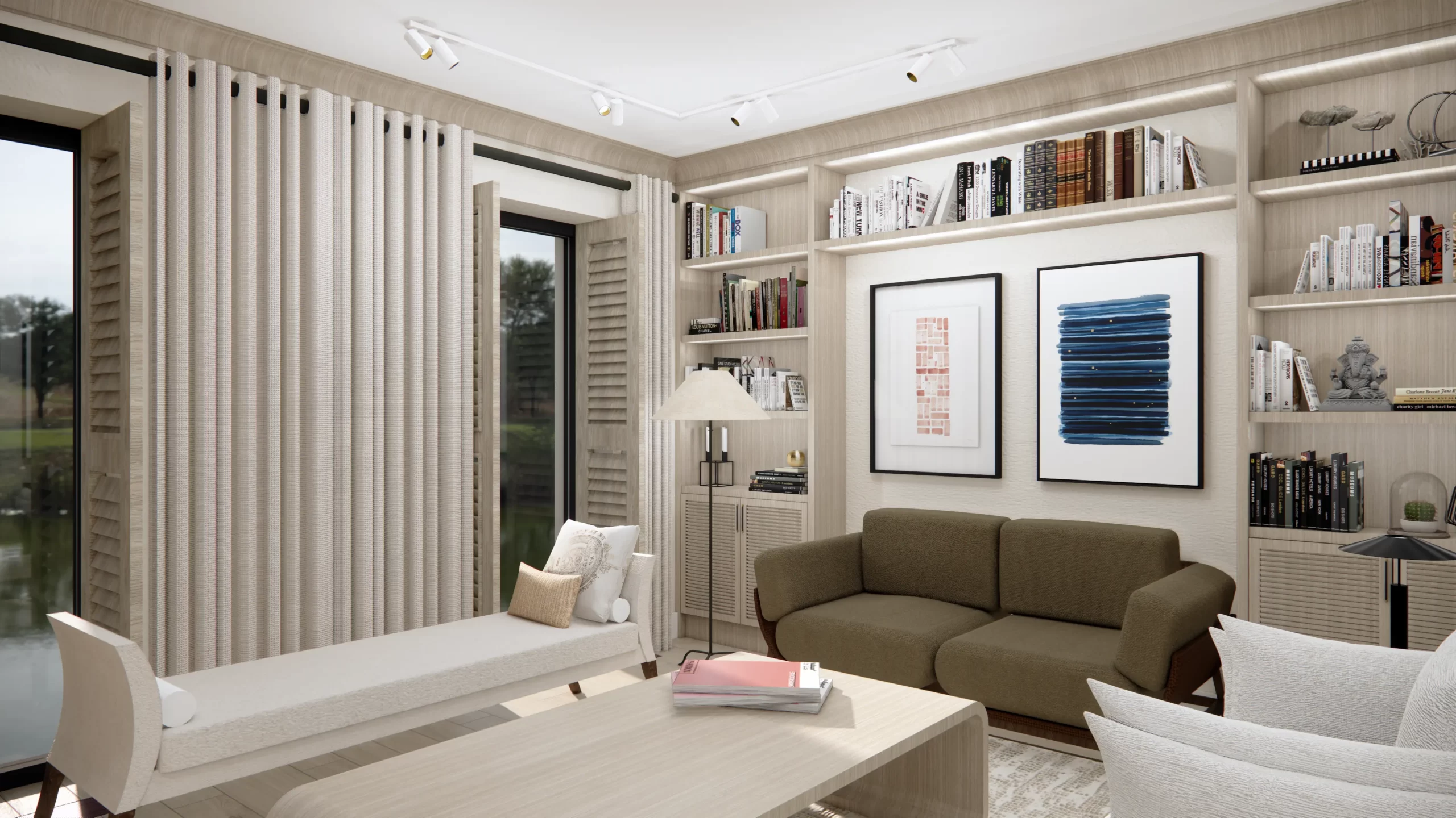 Wyeksponowano oliwkową sofę jako centralny element strefy wypoczynkowej. Zauważalne są także dekoracyjne obrazy w minimalistycznym stylu, które zdobią ścianę za sofą, dodając wnętrzu artystycznego wyrazu. Wnętrze utrzymane jest w jasnej kolorystyce, z dodatkami naturalnego drewna, które ocieplają przestrzeń. Wnękowa zabudowa z półkami stanowi główny element dekoracyjny, a różnorodne książki i dodatki wprowadzają subtelną grę barw i tekstur.